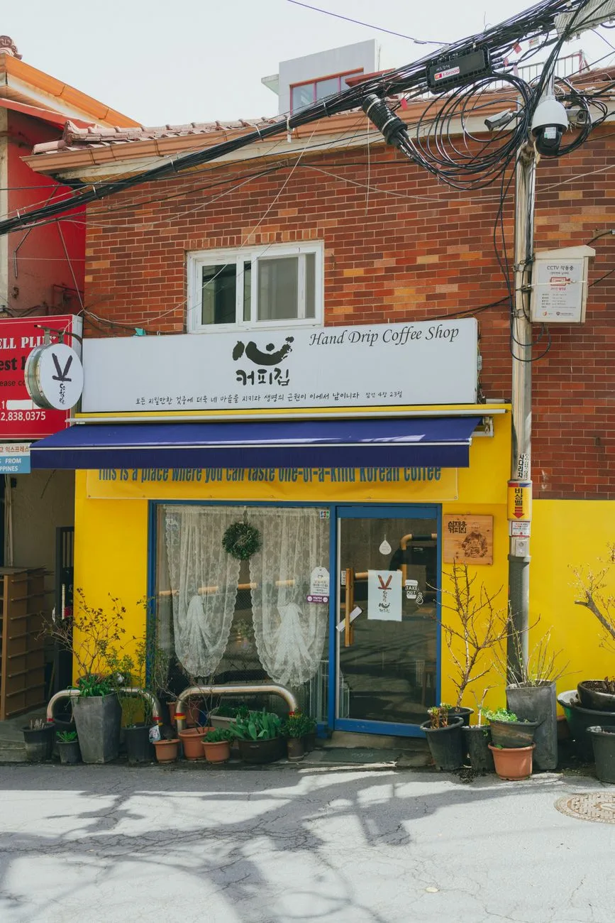 Quaint coffee shop in Seoul with vibrant exterior and charming decor, perfect for café enthusiasts.
