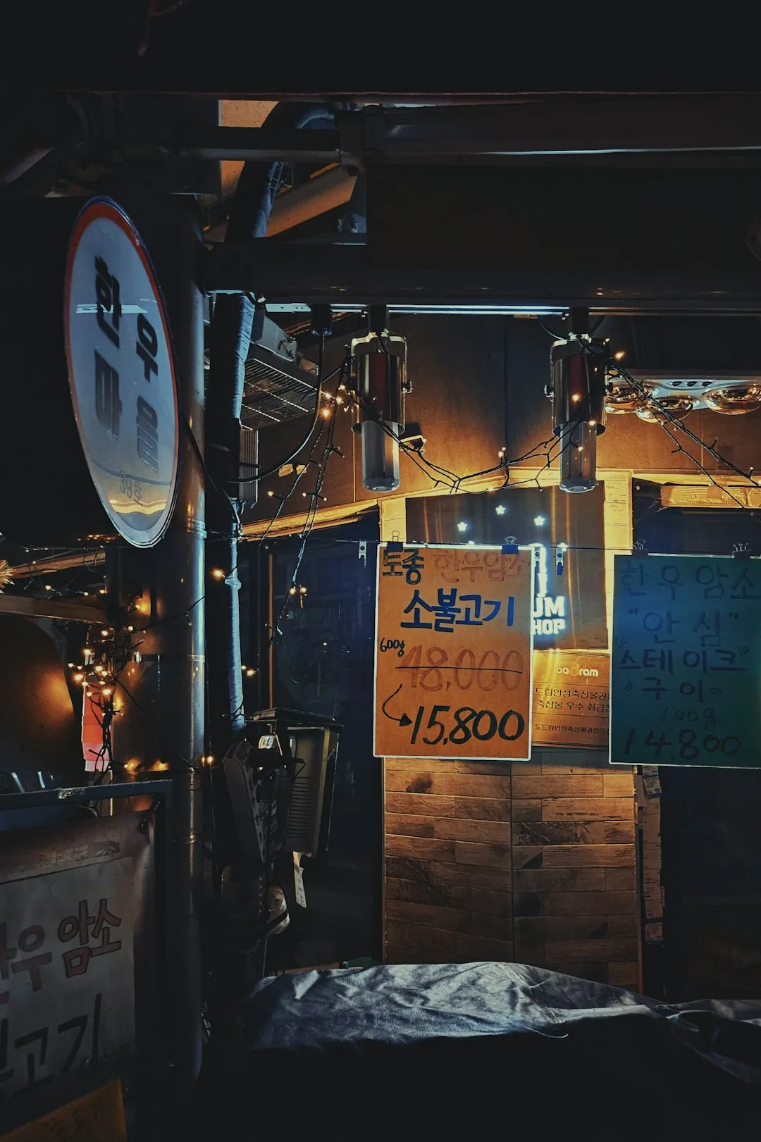 Nighttime street food stall with korean signs.