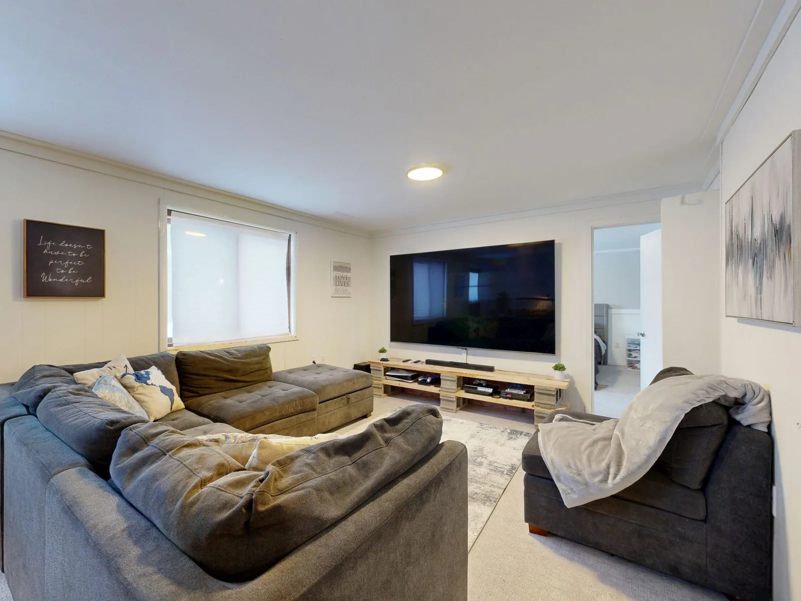 Cozy living room setup with a large screen showing a Korean series