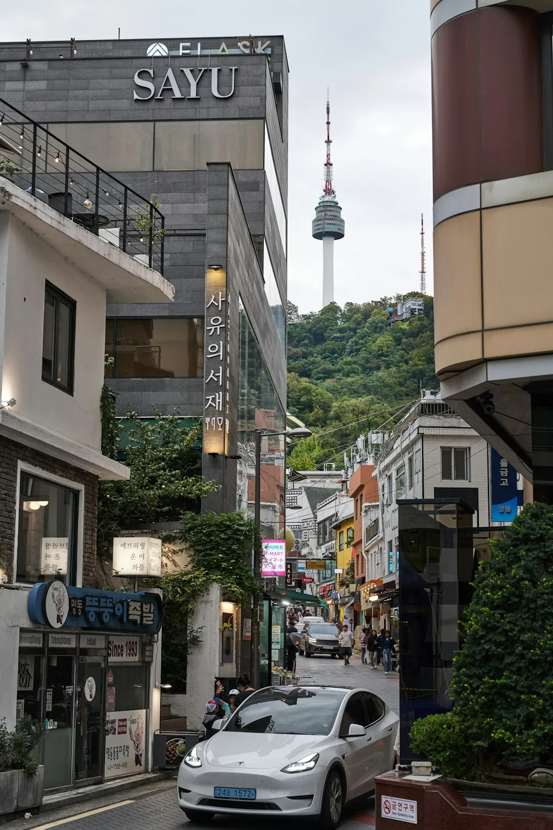 A Seoul street view with Namsan Tower, illustrating how neighborhood choice changes a hotel stay.