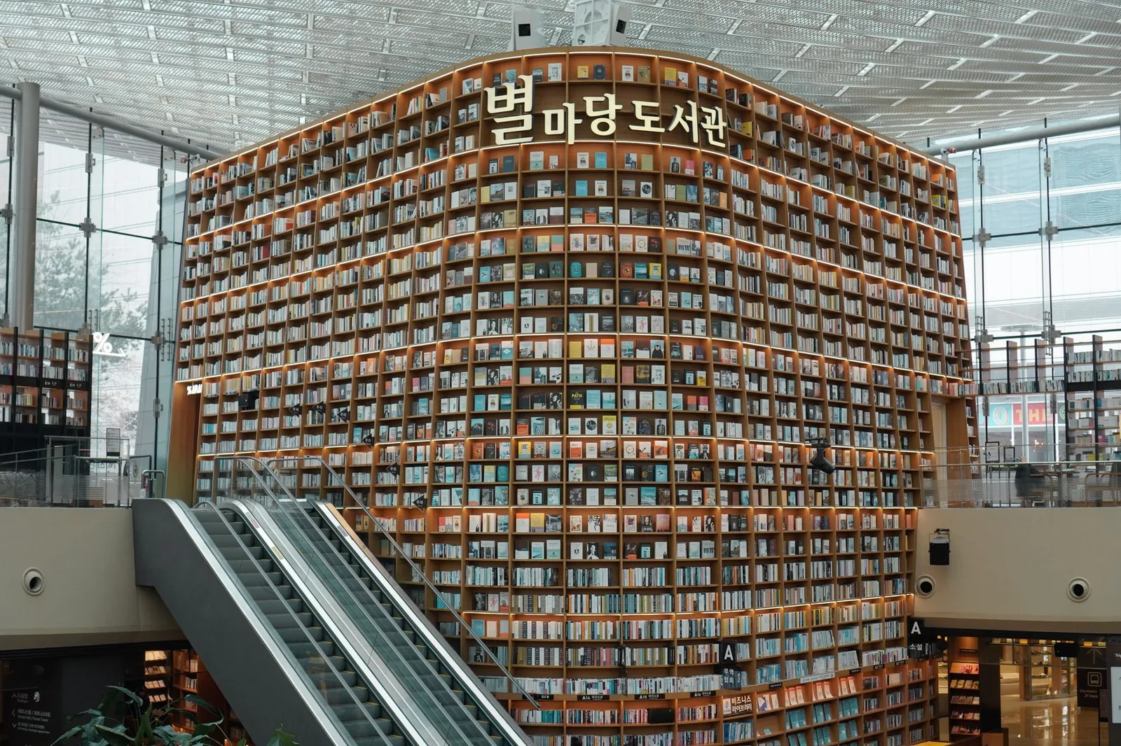 Interior view of Starfield Library with towering bookshelves in Seoul's COEX Mall.