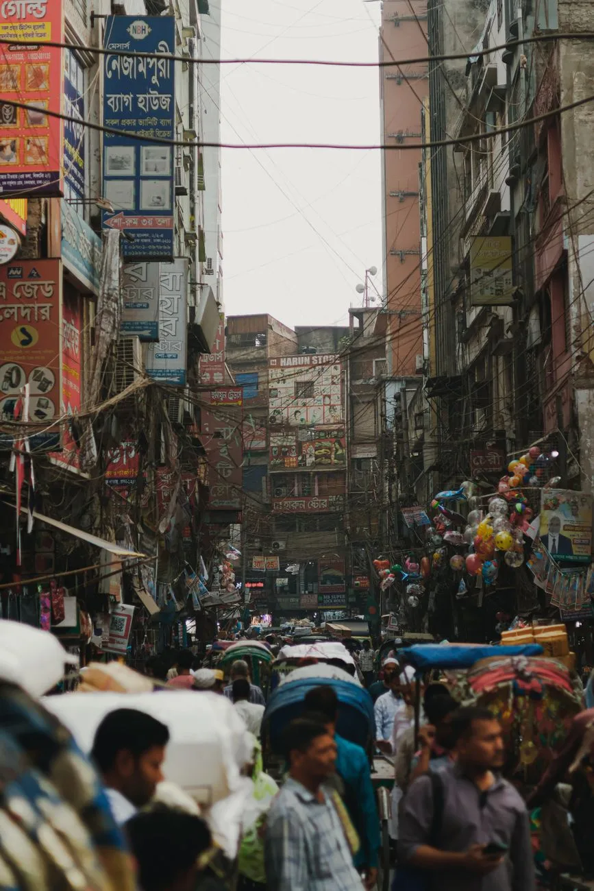 A busy street in Dhaka, Bangladesh, showcasing the vibrant urban lifestyle and crowded market scene.