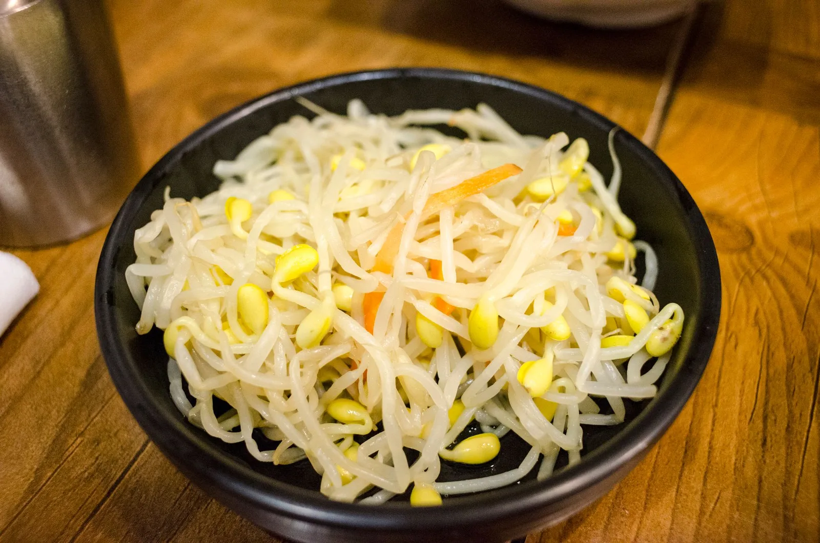 Delicious Korean bean sprouts served as a healthy side dish in a black bowl.