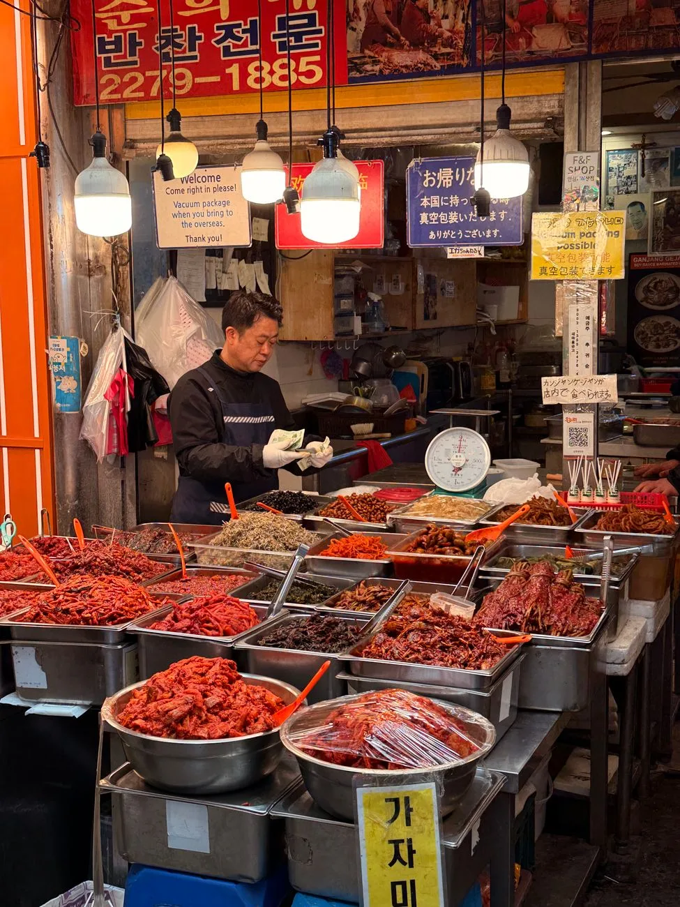 A vibrant Korean market stall displaying a variety of dried seafood and produce, captured in South Korea.