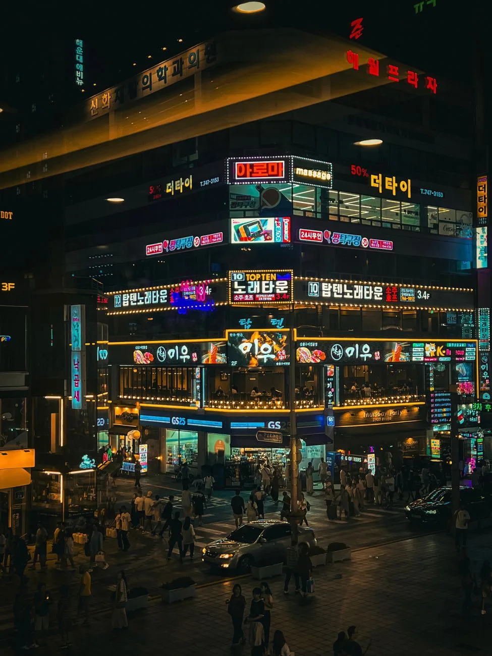 Crowds and neon signs on Myeongdong shopping street in Seoul at night