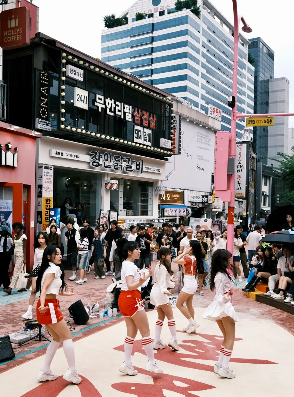 Vibrant street dance performance attracting a lively crowd in Seoul, South Korea.