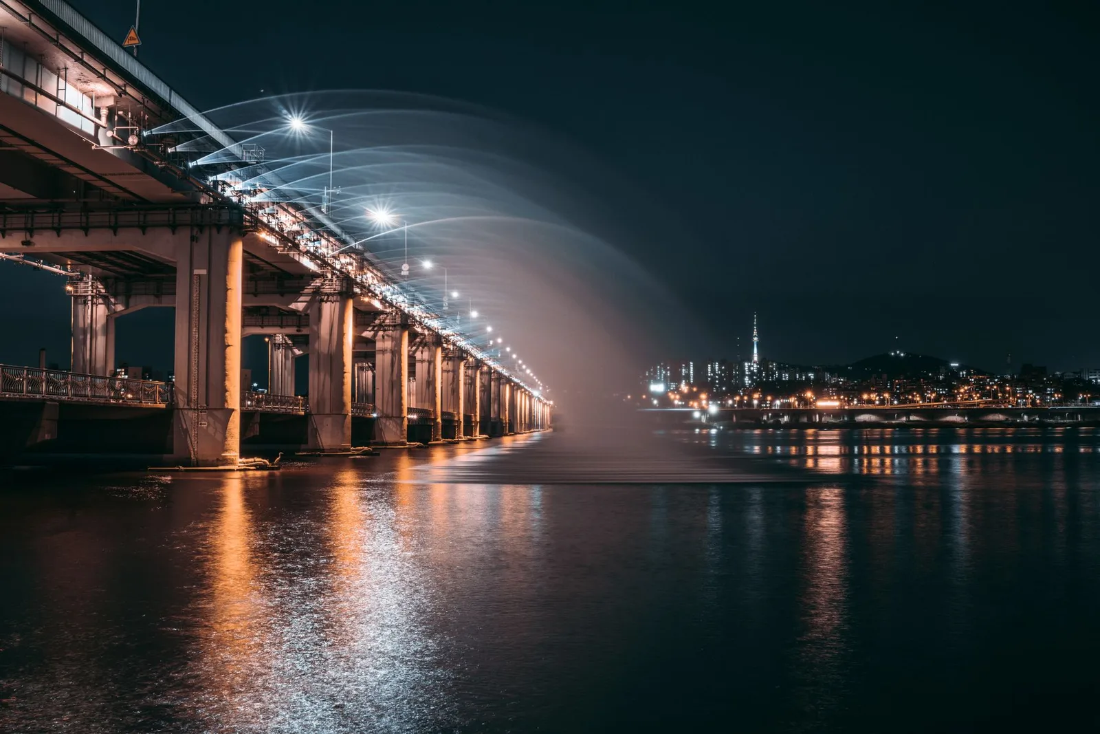 Dramatic night view of Banpo Bridge with Moonlight Rainbow Fountain over Han River in Seoul.