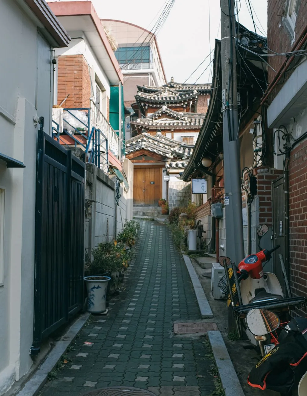 Explore the traditional architecture and serene charm of Bukchon Hanok Village in Seoul, South Korea.