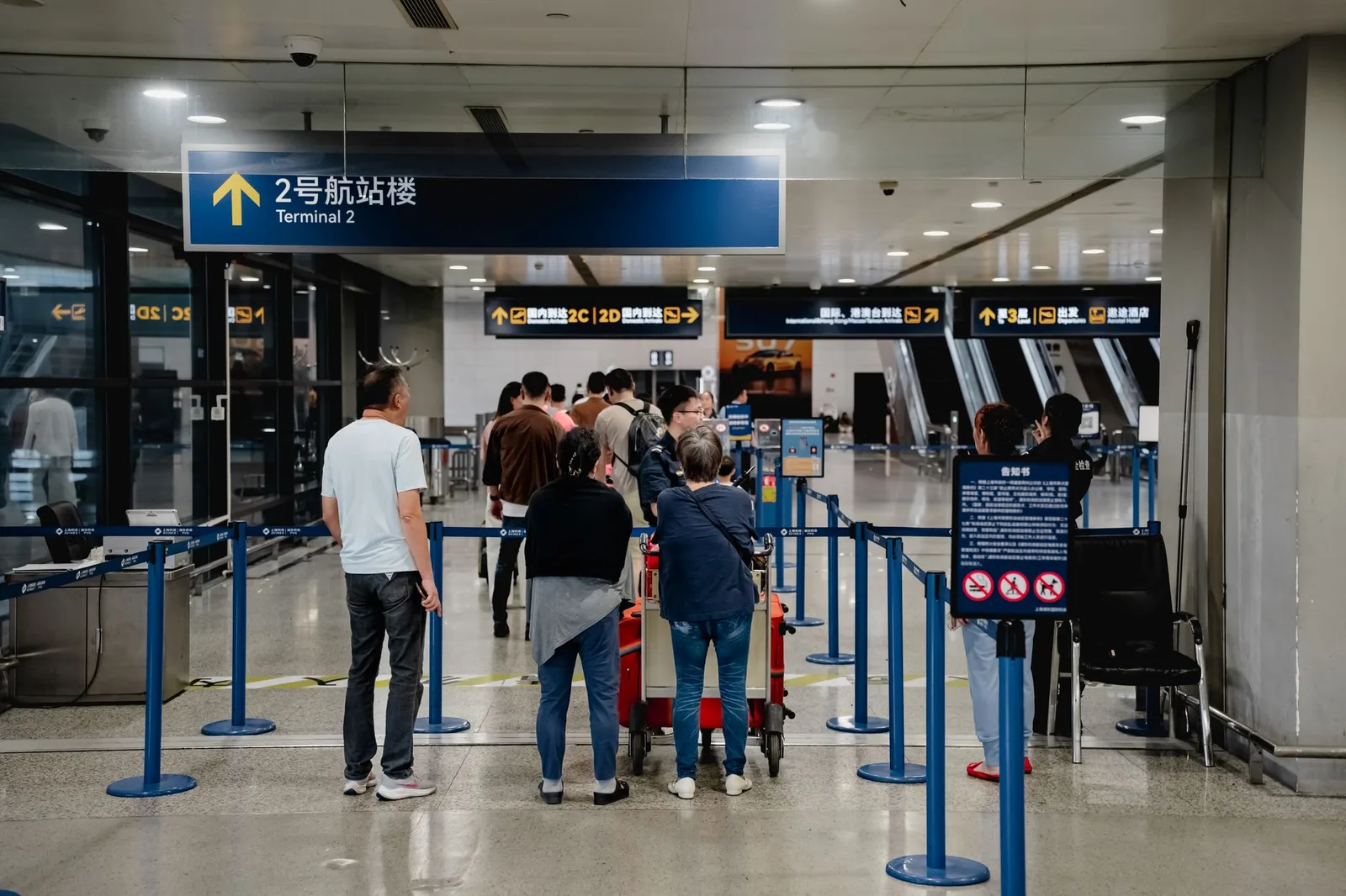 Passengers with luggage in the arrivals hall of Shanghai Pudong International Airport