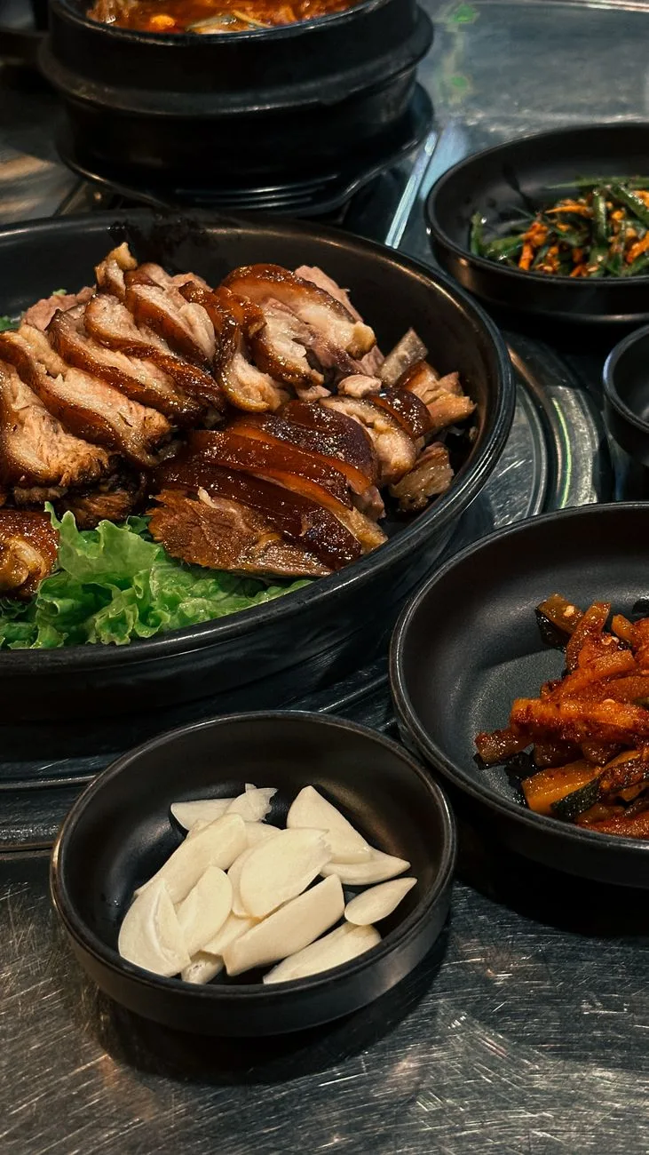 Delicious Korean dishes with pork, kimchi, and garlic served in Ho Chi Minh City restaurant.