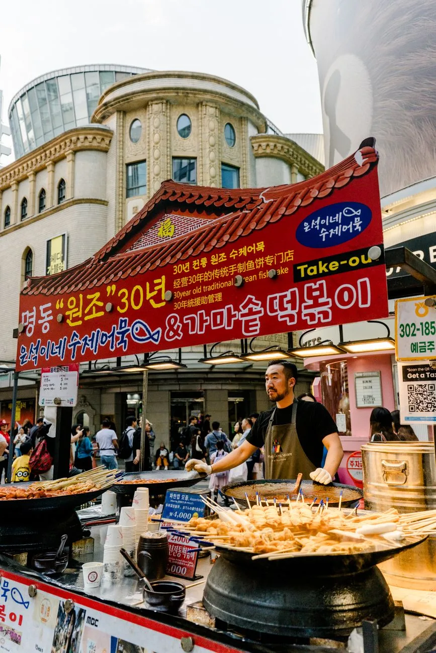 Myeongdong street food stalls with tourists in central Seoul