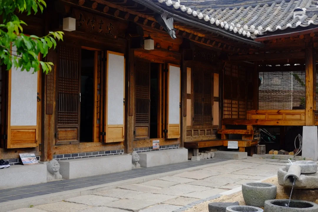 A traditional korean wooden house with a stone courtyard.